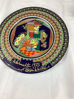 Front view showing full colorful plate with Bjorn Wiinblad 1973 Christmas design and signature.