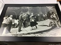 Framed black and white Ruth Orkin poster showing street scene with a woman and men, highlighting overall condition and framing.