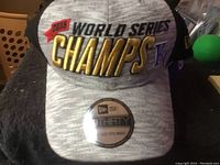 Gray New Era baseball cap with '2015 World Series Champs KC' embroidery on front, mesh back visible