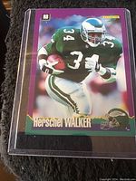 Single close-up photo of one Herschel Walker football card in green Philadelphia Eagles uniform #34, in protective sleeve