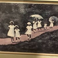 Close-up of signed print of girls walking showing parasols and artist signature Ann Mount