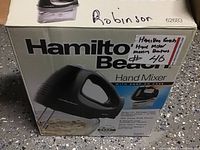 Photo showing Hamilton Beach hand mixer box front with image of black mixer and beaters, model number 62683, with handwritten sticker.