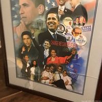 Photo showing the framed print featuring multiple images of Barack Obama and campaign buttons, with visible cracks on the glass.