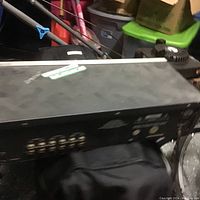 Side view of the black metal equalizer showing connection ports and condition.