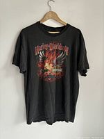 Front view of black Harley-Davidson t-shirt with flaming eagle graphic and Harley-Davidson text.