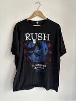 Black Rush band t-shirt with Clockwork Angels Tour 2013 front graphic on hanger.