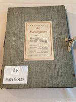 Folio with gray cloth cover and label titled 'Art Masterpieces'