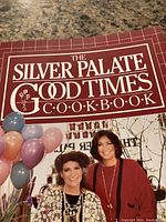 Front cover of The Silver Palate Good Times Cookbook with title and a photo of two women holding balloons.