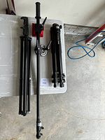 Manfrotto tripod, light boom with boom arm and heavy red counterweight, displayed on table from above