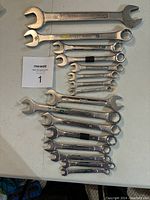 Overview of the full set of imperial and metric combination wrenches laid out on a table.