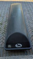 Top view of black car roof box showing length and minor wear