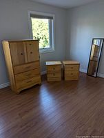 Full view of dresser and two nightstands showing shape and color of wood finish
