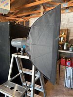 Side view of the Metz lighting unit attached to the rectangular softbox, showing the black softbox material and mount.
