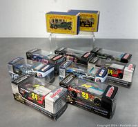 Lot of ten collectible diecast cars comprising vintage Matchbox and Action Racing Collectables NASCAR race cars in original packaging. Photos show cars with racing decals and numbers in original boxes.