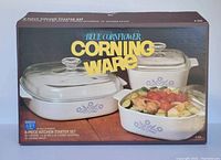 Box with image of 6-piece Blue Cornflower CorningWare starter set showing three casseroles with glass lids and food inside, highlighting set contents and branding