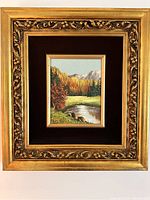 Framed full view of original impressionist landscape painting showing autumn trees, river, meadow, and mountains.