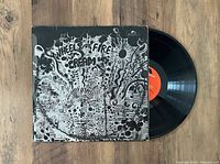 Front cover of Cream's 'Wheels of Fire' black and white psychedelic album art jacket with visible wear.