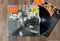 Front cover of Curiosity Killed The Cat Keep Your Distance vinyl record LP with visible insert and part of vinyl disc.