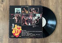 Back cover of the Curtis Mayfield Super Fly vinyl record album showing collage of images and track listing details.