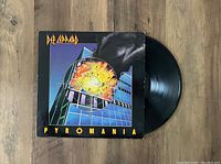 Vinyl record and album cover showing front artwork of Def Leppard's Pyromania LP.