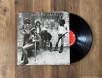 Photo of the Doctor Hook vinyl LP partially pulled out of its black and white photographic jacket showing the band members and red label on the record.