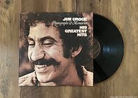 Photo of vinyl record partially outside of album cover showing front cover with Jim Croce's smiling portrait.