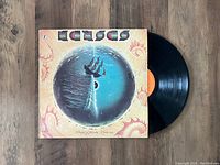 Front cover of the 'Point Of Know Return' vinyl LP by Kansas showing artwork of a ship sailing into a horizon sphere, along with the vinyl disc partially visible.