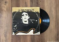 Photo of Lou Reed Transformer vinyl record LP with original album jacket and vinyl record partially visible.
