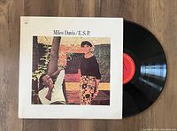 Photo of the vinyl record partially visible with the album jacket showing the cover art of Miles Davis' E.S.P. album, in near mint condition.