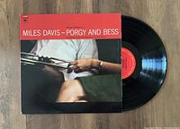 1977 pressing of Miles Davis' Porgy And Bess vinyl LP with jacket and black vinyl disc partially removed from the sleeve.