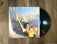 Front cover of Supertramp Breakfast In America vinyl record displaying album art and part of the record itself.