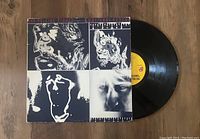 Photo showing the front cover of The Rolling Stones Emotional Rescue vinyl LP and part of the vinyl record with yellow label visible.