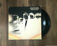 Front of the album jacket showing cover image of The Rolling Stones and partially visible vinyl record.