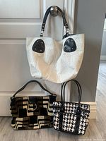 Photo showing three handbags: a white textured handbag with black strap, a black and brown geometric patterned handbag, and a black and white houndstooth handbag.