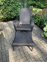 Front view of lounge chair with ottoman on brick patio