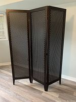 Full view of the three-panel brown wooden room divider with wicker-style lattice panels, showing overall size and design.