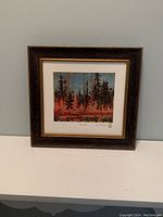 Framed print titled "Tamaracks" by Tom Thomson, showing full artwork and frame.