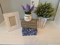 Overall view of all items included in the lot arranged on a white surface against a light-colored wall.