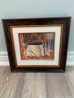 Full front view of framed print showing the entire scene within a dark brown frame with gold trim and off-white mat.