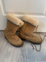 View of both boots side by side showing overall exterior condition, shape, and ties