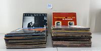 Two stacks of vinyl LP albums including visible covers from Bill Evans and Vince Guaraldi Trio.