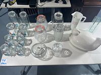 Full view of the table displaying all glass canisters, turkey tureen, roosters, drink pitcher, and vase.