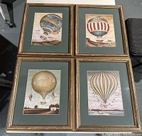 All four framed hot air balloon prints arranged in a square, showing overall condition and framing details.