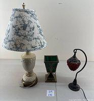 Three vintage table lamps placed side by side showing overview of lot.