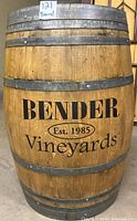 Front side of the wooden barrel showing Bender Vineyards branding with Est. 1985 stamp.