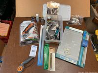 Overview of crafting supplies including rotary cutter (Fiskars), rotary trimmer, gold leaf supplies, sewing kit, and accessories.