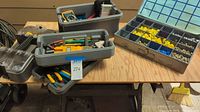 Overview of tool chest and trays with various hand tools and organized plastic trays with hardware