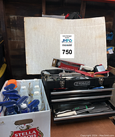 Photo showing Kobalt tool chest filled with grilling tools and case of cleaning chemicals.