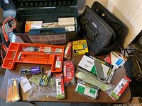 Overview of all items including toolbox, tool bag, and various boxes of nails and staples