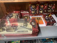 Photo showing a variety of Kwikset door hardware in original packaging including deadbolts, knobs, and handle sets arranged on a shelf.